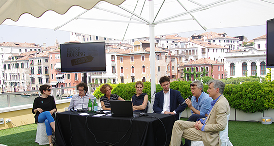 Panelists seated in front of a tent outside the Peggy Guggenheim museum
