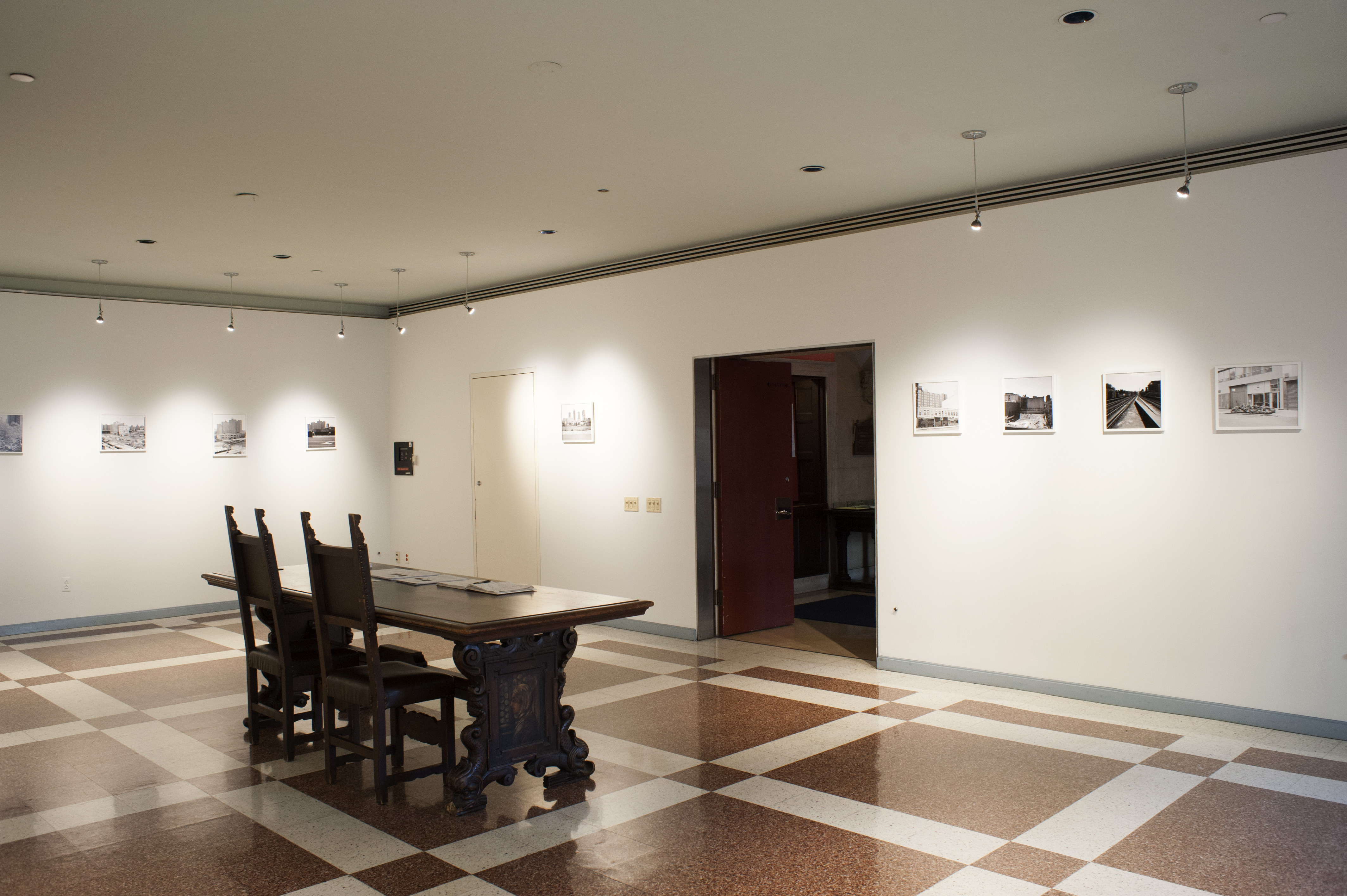 Photo of an exhibition space with photos hung on the wall