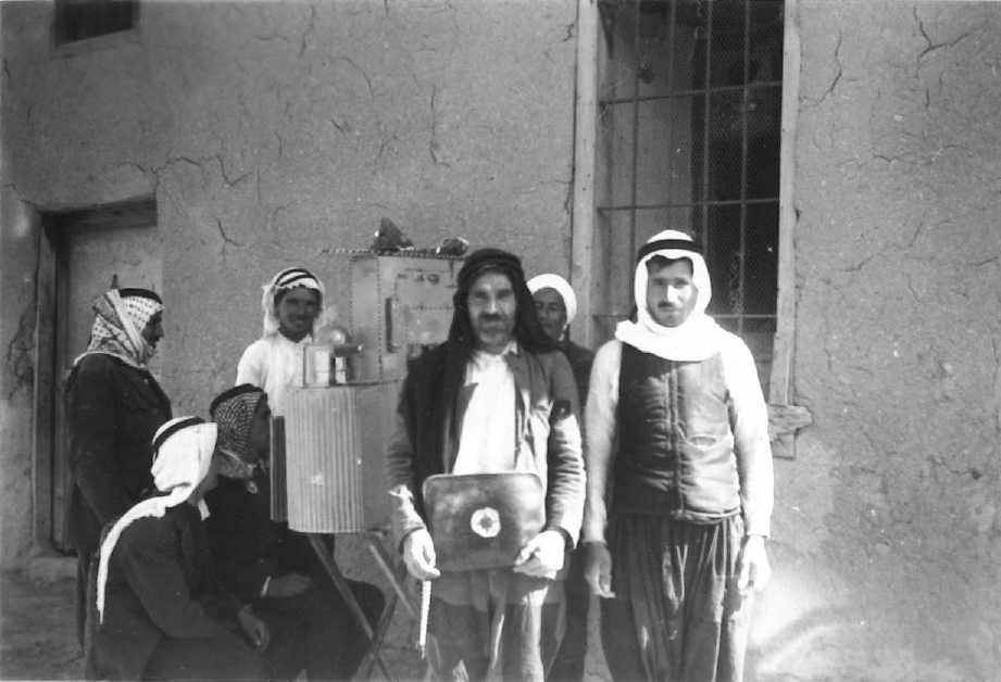 Village Men Gather Around Film Projector, American Friends Service Committee Archive