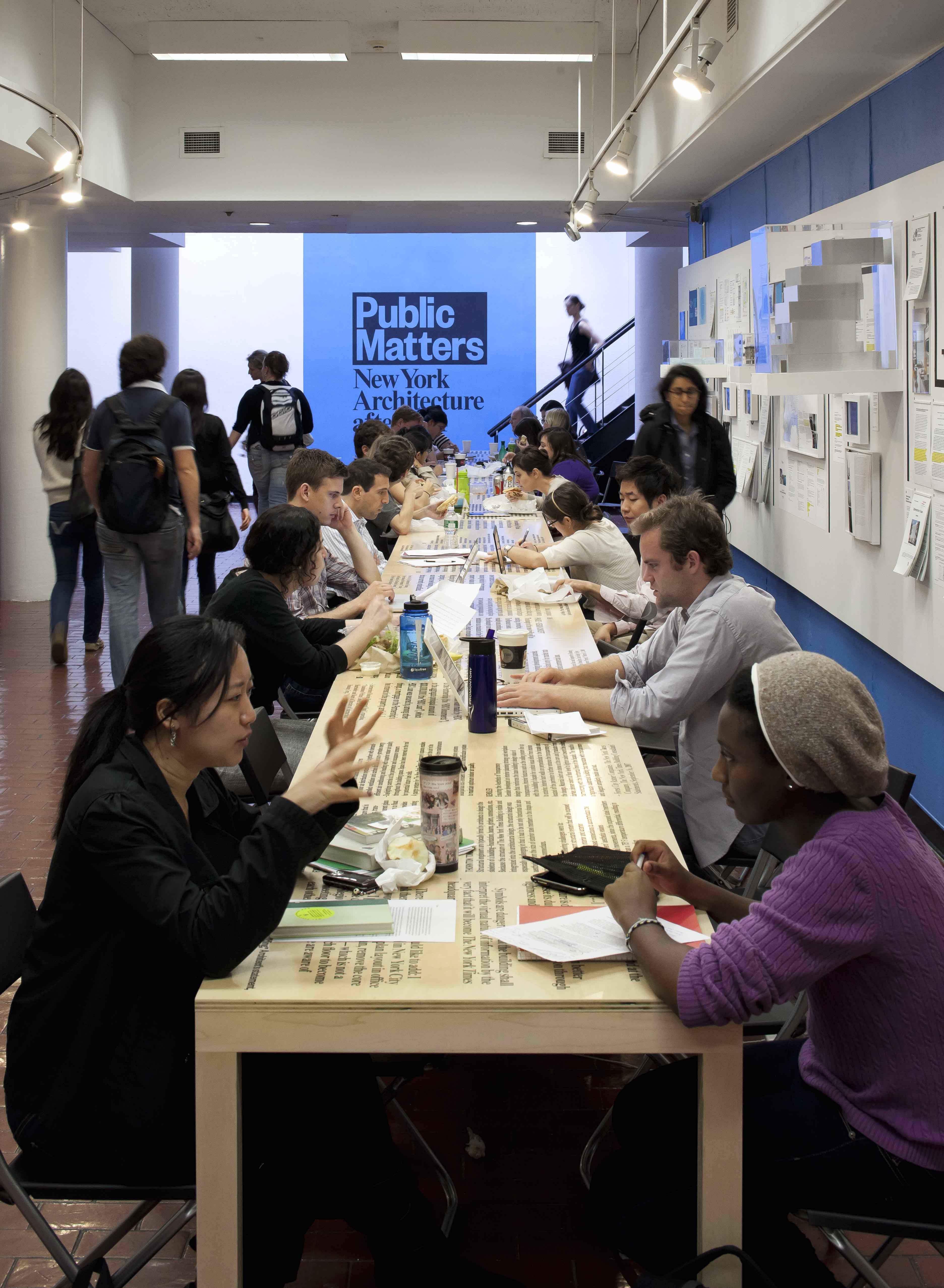 Group of people seated along a long table